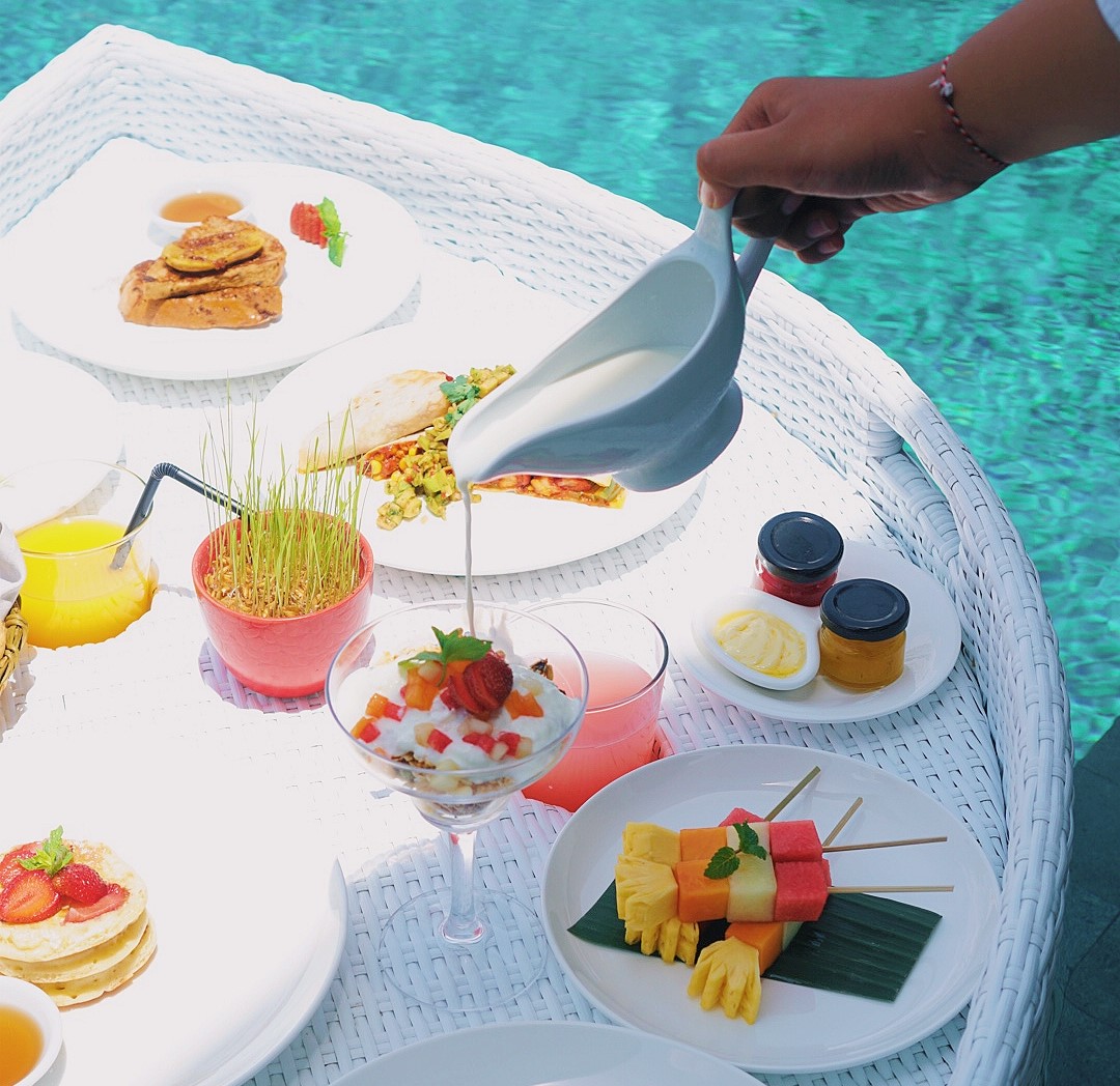 Luxurious floating breakfast served in a private infinity pool at Hideaway Residence Bali, offering a serene and indulgent escape